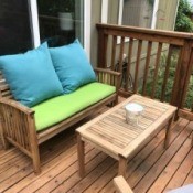 Teak furniture on a deck outdoors.