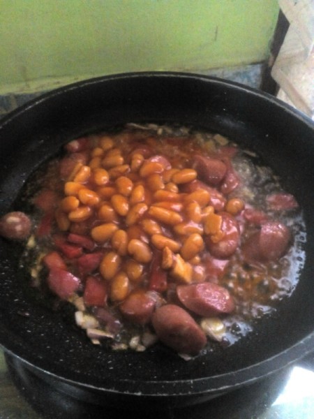 adding beans to pan