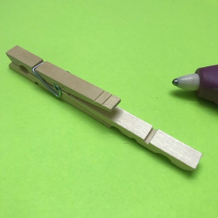 Mini Wooden Clothespin Easel - slide half pin in between the open end of a clothespin and glue in place