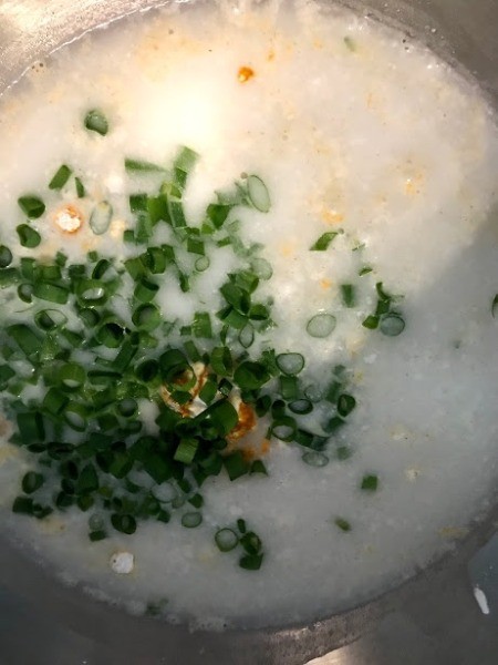adding scallions to bowl