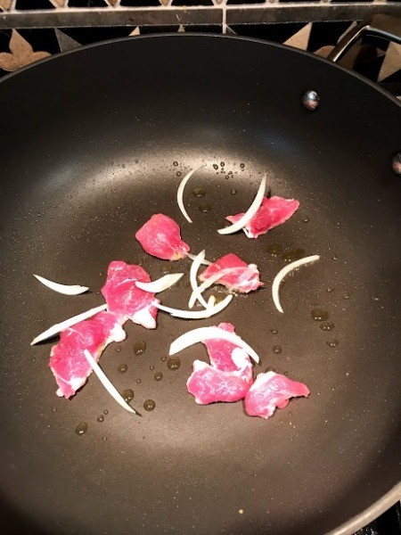 pork and onion in pan