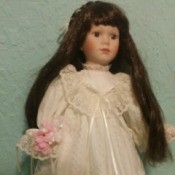 Information and Value of a Dynasty Porcelain Doll - dark haired doll in white long dress