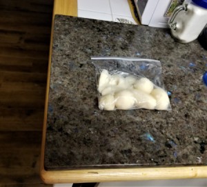 Pieces of potato that have been placed in a plastic ziptop bag.