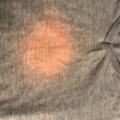 Finding the Cause of Pinkish Orange Stains on Laundry - very large light spot on t-shirt