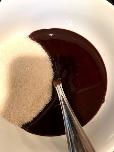 adding sugar to chocolate