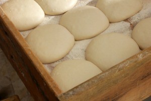 Dough balls on a tray.