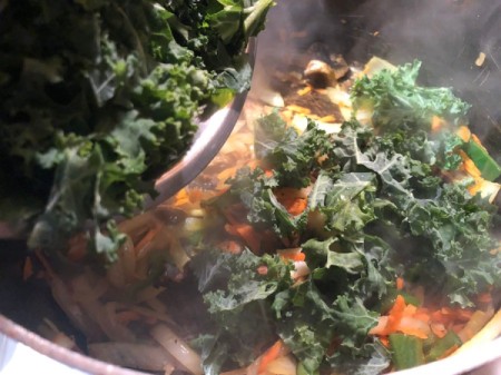 adding kale to pan