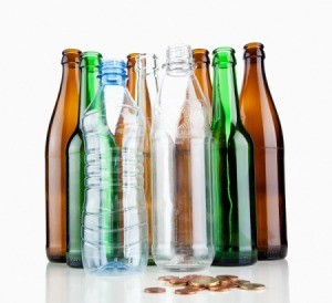 Glass and plastic bottles with change in front of them
