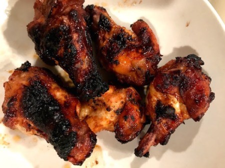 Barbecued chicken that was marinated in BBQ sauce.