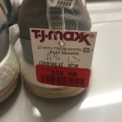A pair of shoes with a marked down price tag.