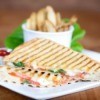 Panini grilled sandwich on a plate.