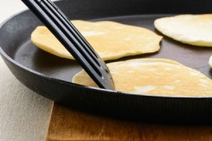 Pancakes cooking in a pan.