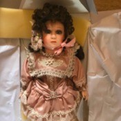 Value of Franklin Heirloom Porcelain Dolls - dark haired doll wearing a dusty rose dress