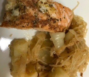 Sautéed Sauerkraut and Potatoes with salmon on plate
