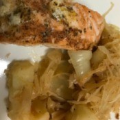 Sautéed Sauerkraut and Potatoes with salmon on plate