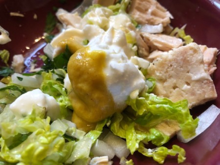adding yogurt and sauce to ingredients