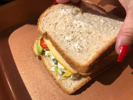 adding top bread slice to sandwich