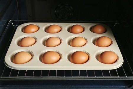 Eggs in a muffin tin in the oven.