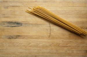 Butcher Block Wood Table with pasta on it.