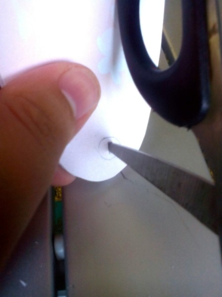 Pocket Sized Hand Fan - make a hole with the scissors