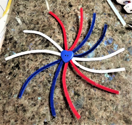Chenille Stem Firework and Star Decorations - create the design for the fireworks this one is curved with button in the center