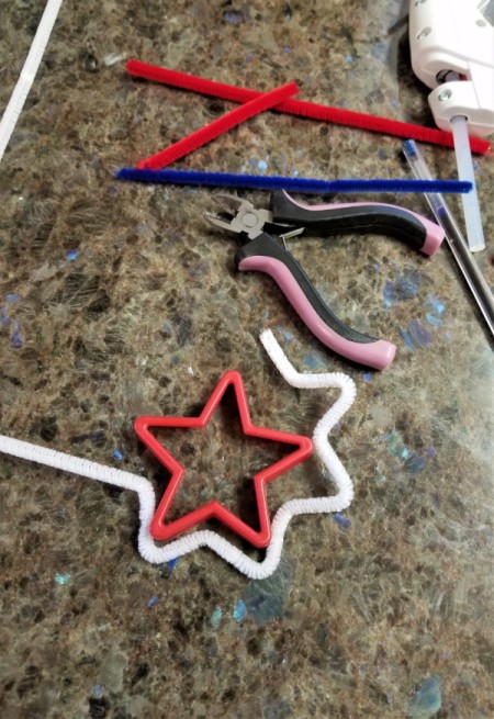 Chenille Stem Firework and Star Decorations - use the cookie cutter to create a star shape