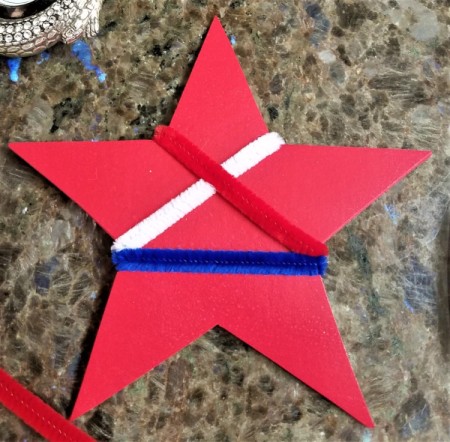 Chenille Stem Firework and Star Decorations - red plastic star wrapped with red, white, and blue chenille stems