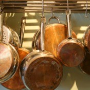 Pots and pans on a pot rack.