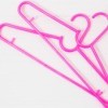 2 pink clothes hangers.