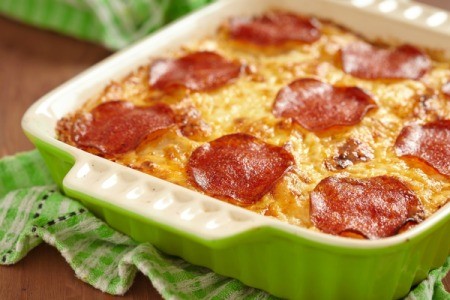 Cavatini in a casserole topped with pepperoni.