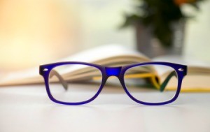 Stylish blue glasses on a blur background.