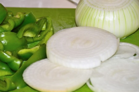 slicing green peppers and onions