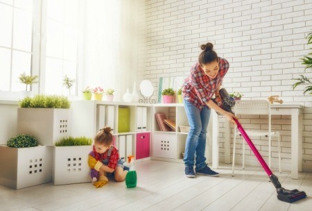 Woman and daughter cleaning house.