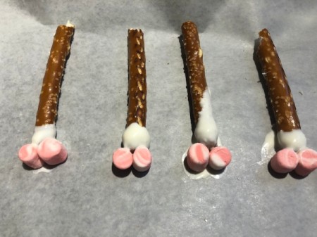 attatching marshmallows to bottom of sticks