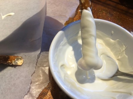 dipping pretzel in candy melt