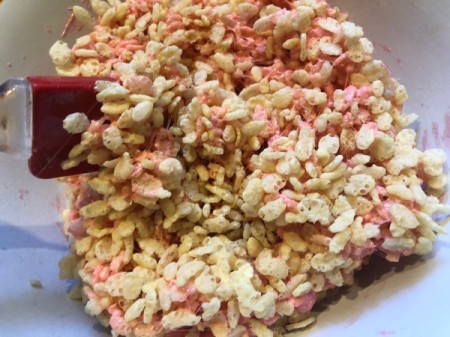 mixing rice crispies with marshmallows