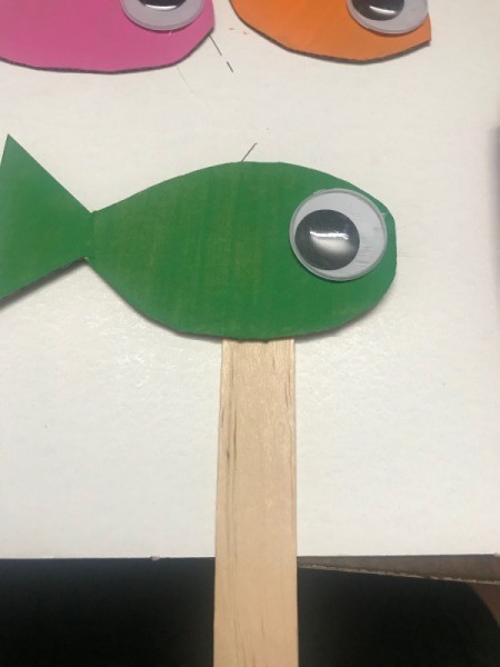 How to Make a Shoebox Theater - glue eye to fish and fish to craft stick