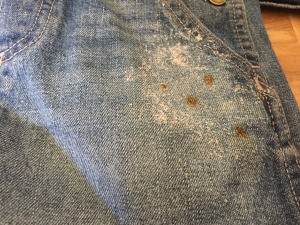 Small rust stains on a pair of denim overalls.