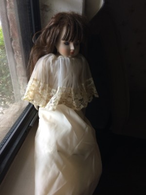Identifying a Childhood Porcelain Doll - doll wearing an long ecru dress with matching short cape