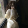 Identifying a Childhood Porcelain Doll - doll wearing an long ecru dress with matching short cape