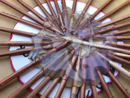 Skewer and Bottle Cap Starburst Art - seal the top side of the skewers with hot glue