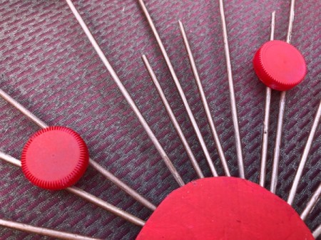 Skewer and Bottle Cap Starburst Art - glue caps to the front of the skewers in  a pleasing pattern