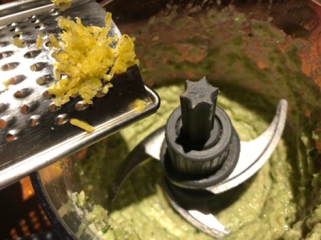 adding garlic to Pesto