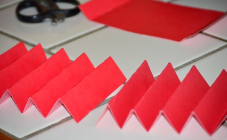 Folded cardstock to be used to organize a kitchen utility crock.