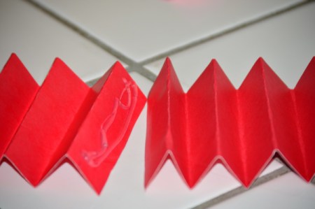 Folded cardstock to be used to organize a kitchen utility crock.