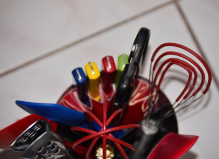 An organized kitchen utility crock.