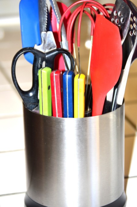 An organized kitchen utility crock.