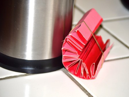 Folded cardstock to be used to organize a kitchen utility crock.
