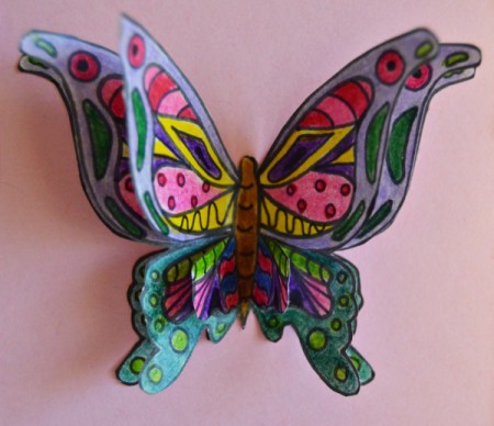 3D Ornamental Butterfly Birthday Card - glue a butterfly to the card inside the frame, partially glue down a second butterfly, and finally, the front wings, body, and part of the back wings of a third and glue in place - body only not the wings, allow to