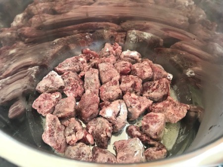 floured beef in pot